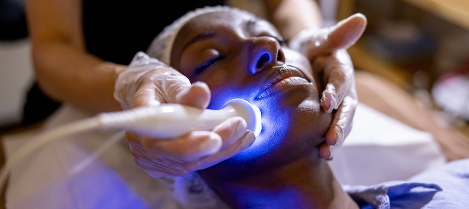 A woman undergoing UVB light therapy treatment for skin conditions, mood disorders, and immune support.